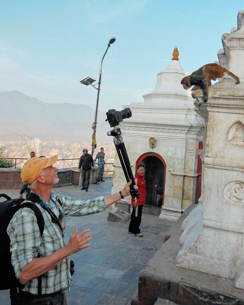 Camp Photo Tour leader Richard Camp photographing a monkey at the Swoyambhu Mahachaitya temple in Katmandu, Nepal.