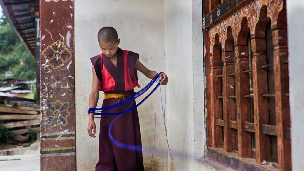 A shaiksha, student of Buddhism, gathers yarn at a monastery