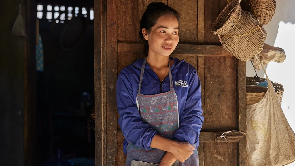 A Laos villager poses outside her home.